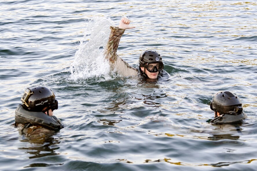 Staff Sgt. Dallas Stoll (center), 22nd Special Tactics Squadron combat controller instructs two Airmen from the 22nd STS Red Team on the proper technique for hoist extraction operations July 14, 2014, during helocast alternate insertion and extraction training with Soldiers from the 160th Special Operations Aviation Regiment at American Lake on Joint Base Lewis-McChord, Washington. Stoll, a helocast master, was chosen to be the team leader for the exercise to ensure the members of Red Team could get the proper upgrade training. (U.S. Air Force photo/Staff Sgt. Russ Jackson) 


