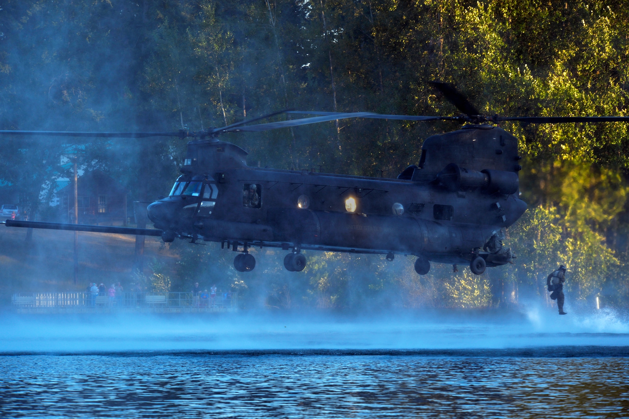 An Airman from the 22nd Special Tactics Squadron’s Red Team jumps out of an MH-47 Chinook helicopter July 14, 2014, during helocast alternate insertion and extraction training with Soldiers from the 160th Special Operations Aviation Regiment at American Lake on Joint Base Lewis-McChord, Wash. The 160th SOAR was tasked with AIE training and called the 22nd STS in hopes their Airmen would have the training requirement to take part in the exercise. (U.S. Air Force photo/Staff Sgt.Russ Jackson)