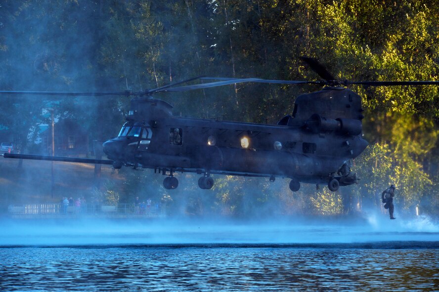 An Airman from the 22nd Special Tactics Squadron’s Red Team jumps out of an MH-47 Chinook helicopter July 14, 2014, during helocast alternate insertion and extraction training with Soldiers from the 160th Special Operations Aviation Regiment at American Lake on Joint Base Lewis-McChord, Washington. The 160th SOAR was tasked with AIE training and called the 22nd STS in hopes their Airmen would have the training requirement to take part in the exercise. (U.S. Air Force photo/Staff Sgt.Russ Jackson) 

