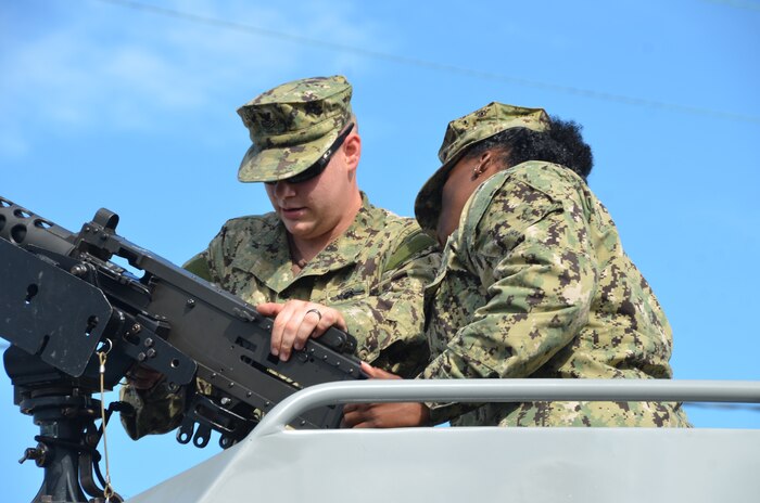 Seaman Marvin Marshall, a Navy master-at-arms, and Petty Officer 2nd Class Miranda Marable, a Navy gunner’s mate, secure an M 240 machine gun onboard a Coastal Riverine Squadron 10 patrol boat July 7, 2014, at Joint Base Charleston, S.C. CRS 10 is a Reserve unit home-based at JB Charleston and part of the Coastal Riverine Force which is comprised of three active-duty squadrons and four Reserve Squadrons. The units operate in harbors, rivers, bays, across the littorals and ashore. Their primary mission is to conduct maritime security operations across all phases of military operations by defending high value assets, critical maritime infrastructure, ports and harbors both inland and on coastal waterways against enemies, and when commanded, conduct offensive combat operations. (U.S. Air Force photo/Eric Sesit)  