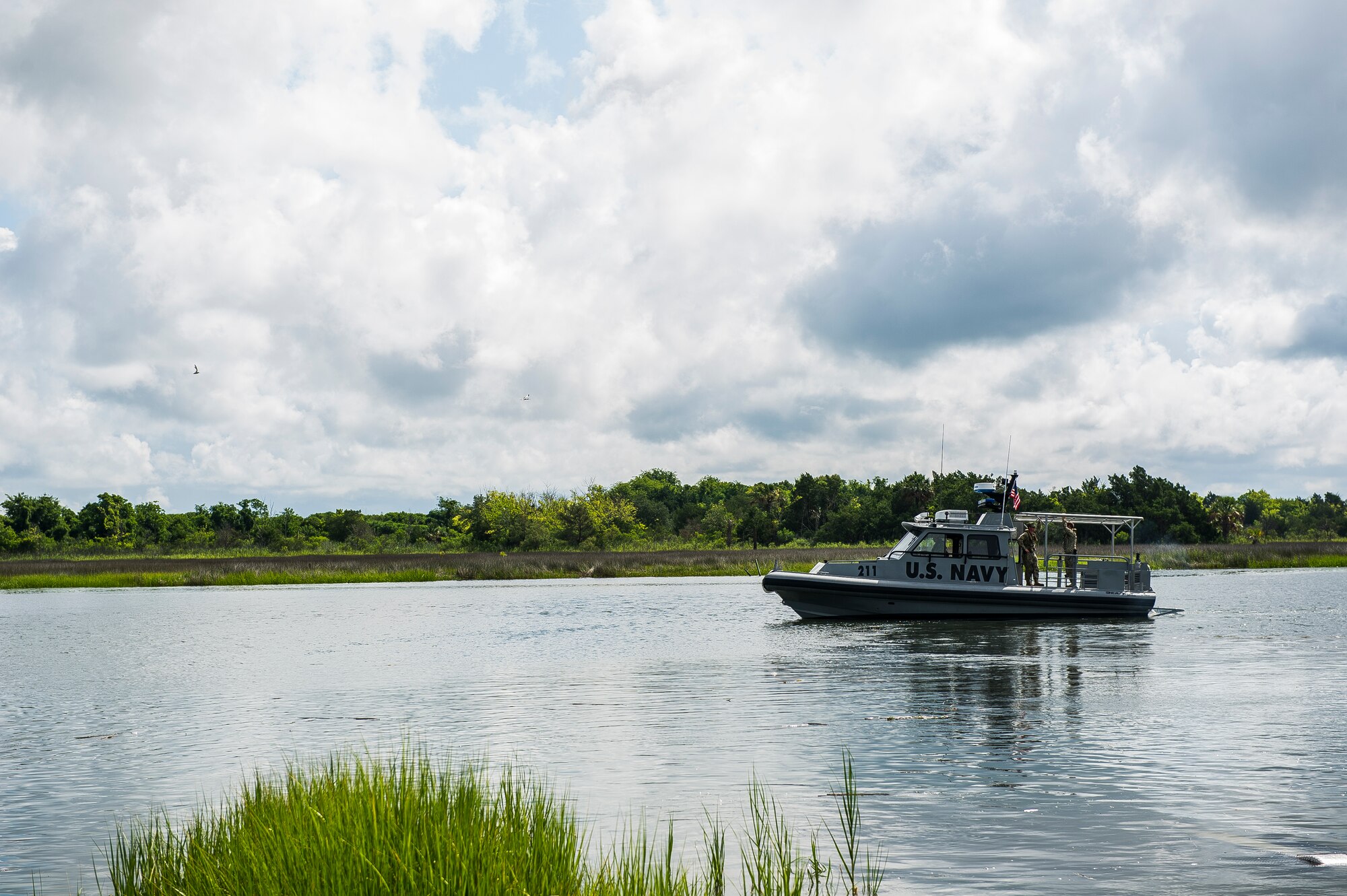 After launching, members of Coastal Riverine Squadron 10, a U.S. Navy Reserve unit home-based at Joint Base Charleston, prepare for the day’s operations along the Cooper River, July 12, 2014, at JB Charleston, S.C. CRS 10 is part of the Coastal Riverine Force which is comprised of three active-duty squadrons and four Reserve Squadrons. The units operate in harbors, rivers, bays, across the littorals and ashore. Their primary mission is to conduct maritime security operations across all phases of military operations by defending high value assets, critical maritime infrastructure, ports and harbors both inland and on coastal waterways against enemies, and when commanded, conduct offensive combat operations. (U.S. Air Force photo/Senior Airman George Goslin)