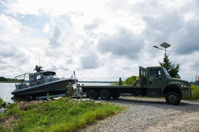 Trailering, launching and recovery are all part of a day’s work for members of Coastal Riverine Squadron 10, a U.S. Navy Reserve unit home-based at Joint Base Charleston, as they launch their patrol boat into the Cooper River, July 12, 2014, at JB Charleston, S.C. CRS 10 is part of the Coastal Riverine Force which is comprised of three active-duty squadrons and four Reserve Squadrons. The units operate in harbors, rivers, bays, across the littorals and ashore. Their primary mission is to conduct maritime security operations across all phases of military operations by defending high value assets, critical maritime infrastructure, ports and harbors both inland and on coastal waterways against enemies, and when commanded, conduct offensive combat operations. (U.S. Air Force photo/Senior Airman George Goslin)