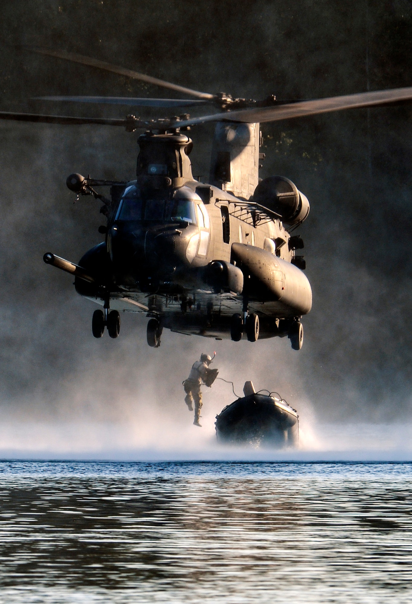 An Airman from the 22nd Special Tactics Squadron’s Red Team jumps out of an MH-47 Chinook helicopter July 14, 2014, during helocast alternate insertion and extraction training with Soldiers from the 160th Special Operations Aviation Regiment at American Lake on Joint Base Lewis-McChord, Wash. The Airmen from the STS conducted 10 daytime helocast iterations and eight nighttime helocast iterations over a two-day span. (U.S. Air Force photo/Staff Sgt. Russ Jackson)