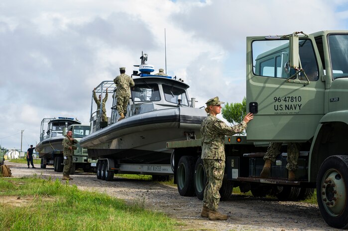 Members of Coastal Riverine Squadron 10, a U.S. Navy Reserve unit home-based at Joint Base Charleston, prepare for the day’s operations as they tow their boats to a ramp for launching, July 12, 2014, at JB Charleston, S.C. CRS 10 is part of the Coastal Riverine Force which is comprised of three active-duty squadrons and four Reserve Squadrons. The units operate in harbors, rivers, bays, across the littorals and ashore. Their primary mission is to conduct maritime security operations across all phases of military operations by defending high value assets, critical maritime infrastructure, ports and harbors both inland and on coastal waterways against enemies, and when commanded, conduct offensive combat operations.  (U.S. Air Force photo/Senior Airman George Goslin)