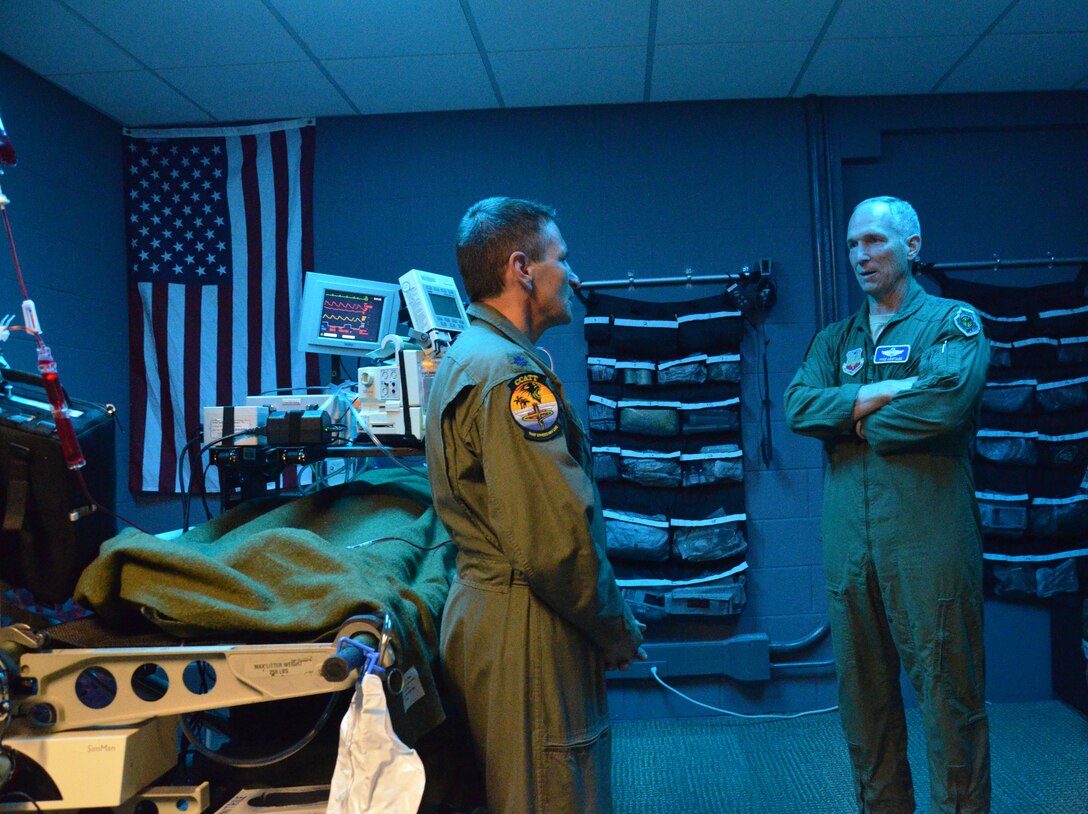 Lt. Col. Steven Podnos (left), 920th Aeromedical Staging Squadron flight doctor, Patrick Air Force Base, Fla., showcases the units simulator center to Gen. Michael Hostage (right), Air Combat Command commander, July 15, 2014. The training center simulates a flying intensive care unit on a C-17 Globemaster cargo aircraft and a C-130P/N refueling aircraft. (U.S. Air Force photo/Senior Airman Natasha Dowridge)
