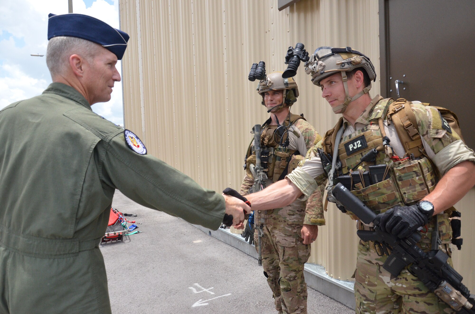 Gen. Michael Hostage, Air Combat Command Commander, greets Staff Sgt. Andrew West (left) and Senior Airman Philip Sherman (right) pararescuemen with the 308th Rescue during his visit of the 920th Rescue Wing, Patrick Air Force Base, Fla. (U.S. Air Force photo/Senior Airman Natasha Dowridge)