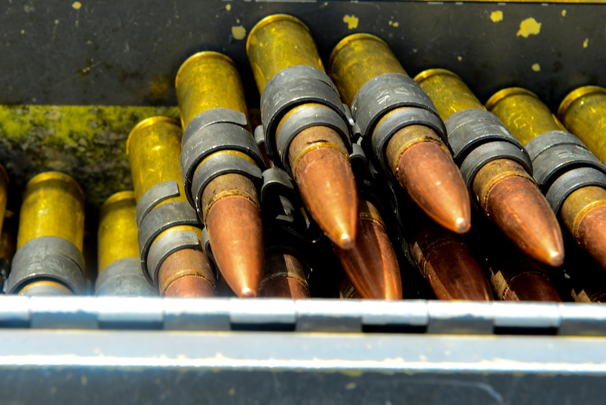 A chain of .50-caliber bullets rest in an ammo canister at Moody Air Force Base, Ga.,  July 10, 2014. The .50-caliber machine gun is what special missions aviators primarily use when deployed. (U.S.  Air Force Airman 1st Class Ceaira Tinsley/Released)
