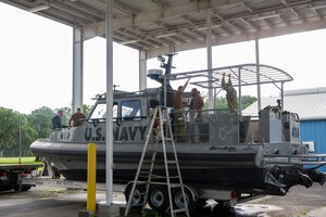 Members of Coastal Riverine Squadron 10, a U.S. Navy Reserve unit home-based at Joint Base Charleston, prepare one of their patrol boats July 12, 2014, at JB Charleston, S.C. CRS 10 is part of the Coastal Riverine Force which is comprised of three active-duty squadrons and four Reserve Squadrons. The units operate in harbors, rivers, bays, across the littorals and ashore. Their primary mission is to conduct maritime security operations across all phases of military operations by defending high value assets, critical maritime infrastructure, ports and harbors both inland and on coastal waterways against enemies, and when commanded, conduct offensive combat operations. (U.S. Air Force photo/Senior Airman George Goslin)