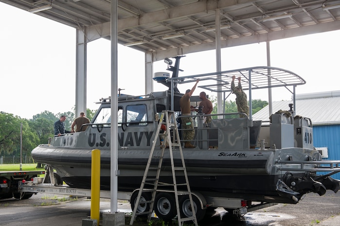 Members of Coastal Riverine Squadron 10, a U.S. Navy Reserve unit home-based at Joint Base Charleston, prepare one of their patrol boats July 12, 2014, at JB Charleston, S.C. CRS 10 is part of the Coastal Riverine Force which is comprised of three active-duty squadrons and four Reserve Squadrons. The units operate in harbors, rivers, bays, across the littorals and ashore. Their primary mission is to conduct maritime security operations across all phases of military operations by defending high value assets, critical maritime infrastructure, ports and harbors both inland and on coastal waterways against enemies, and when commanded, conduct offensive combat operations. (U.S. Air Force photo/Senior Airman George Goslin)