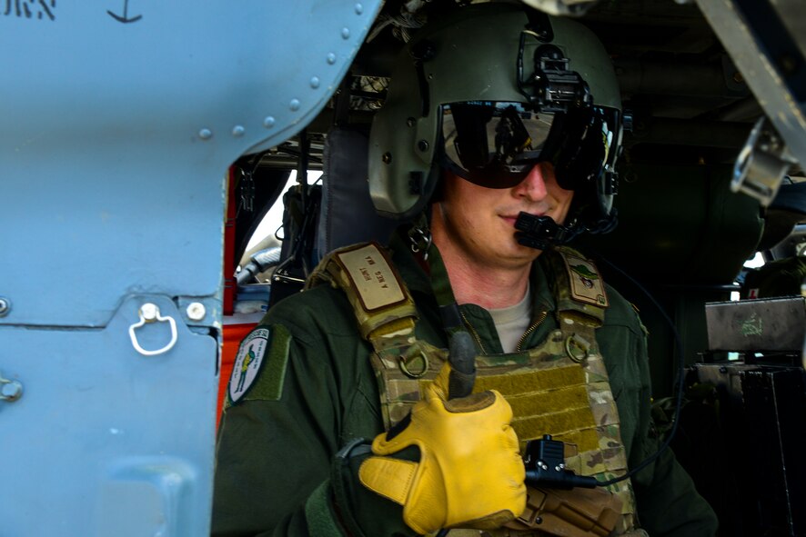 U.S. Air Force Tech. Sgt. Russell Hunt, 41st Rescue Squadron NCO in charge of weapons tactics, gives a thumbs up as he prepares for takeoff at Moody Air Force Base, Ga., July 10, 2014. In this training scenario, Hunt and his team had to locate and rescue one simulated injured person. (U.S.  Air Force Airman 1st Class Ceaira Tinsley/Released)