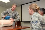 Tech. Sgt. Sarah Hanaway, 359th Medical Group NCOIC of Medical Training Programs, teaches basic CPR to Airmen assigned to the 359th MDG, July 15, at Joint Base San Antonio-Randolph. Hanaway is a Basic Life Support instructor and teaches resuscitation methods on a mannequin by demonstrating two-inch deep chest compressions and giving breaths with a one way valve pocket mask.  Hanaway is this week’s Warrior of the Week for the 59th Medical Wing. (U.S. Air Force photo by Johnny Saldivar)