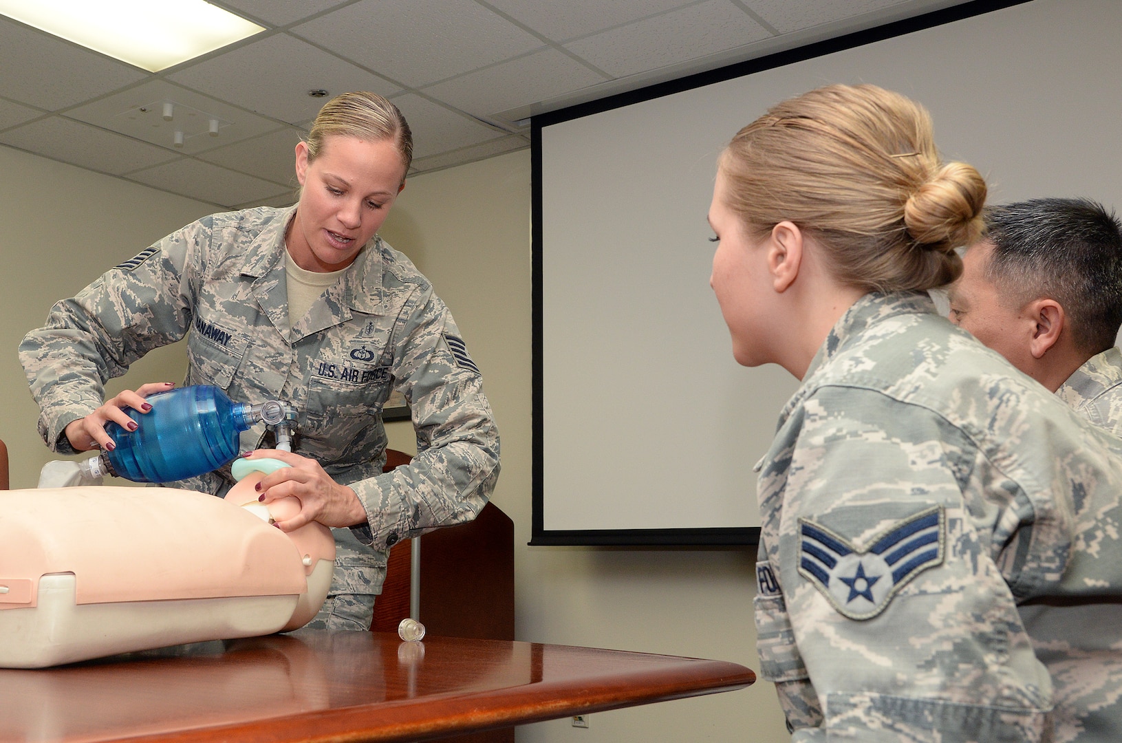 Tech. Sgt. Sarah Hanaway, 359th Medical Group NCOIC of Medical Training Programs, teaches basic CPR to Airmen assigned to the 359th MDG, July 15, at Joint Base San Antonio-Randolph. Hanaway is a Basic Life Support instructor and teaches resuscitation methods on a mannequin by demonstrating two-inch deep chest compressions and giving breaths with a one way valve pocket mask.  Hanaway is this week’s Warrior of the Week for the 59th Medical Wing. (U.S. Air Force photo by Johnny Saldivar)