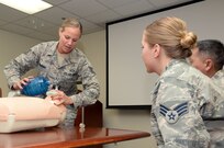 Tech. Sgt. Sarah Hanaway, 359th Medical Group NCOIC of Medical Training Programs, teaches basic CPR to Airmen assigned to the 359th MDG, July 15, at Joint Base San Antonio-Randolph. Hanaway is a Basic Life Support instructor and teaches resuscitation methods on a mannequin by demonstrating two-inch deep chest compressions and giving breaths with a one way valve pocket mask.  Hanaway is this week’s Warrior of the Week for the 59th Medical Wing. (U.S. Air Force photo by Johnny Saldivar)