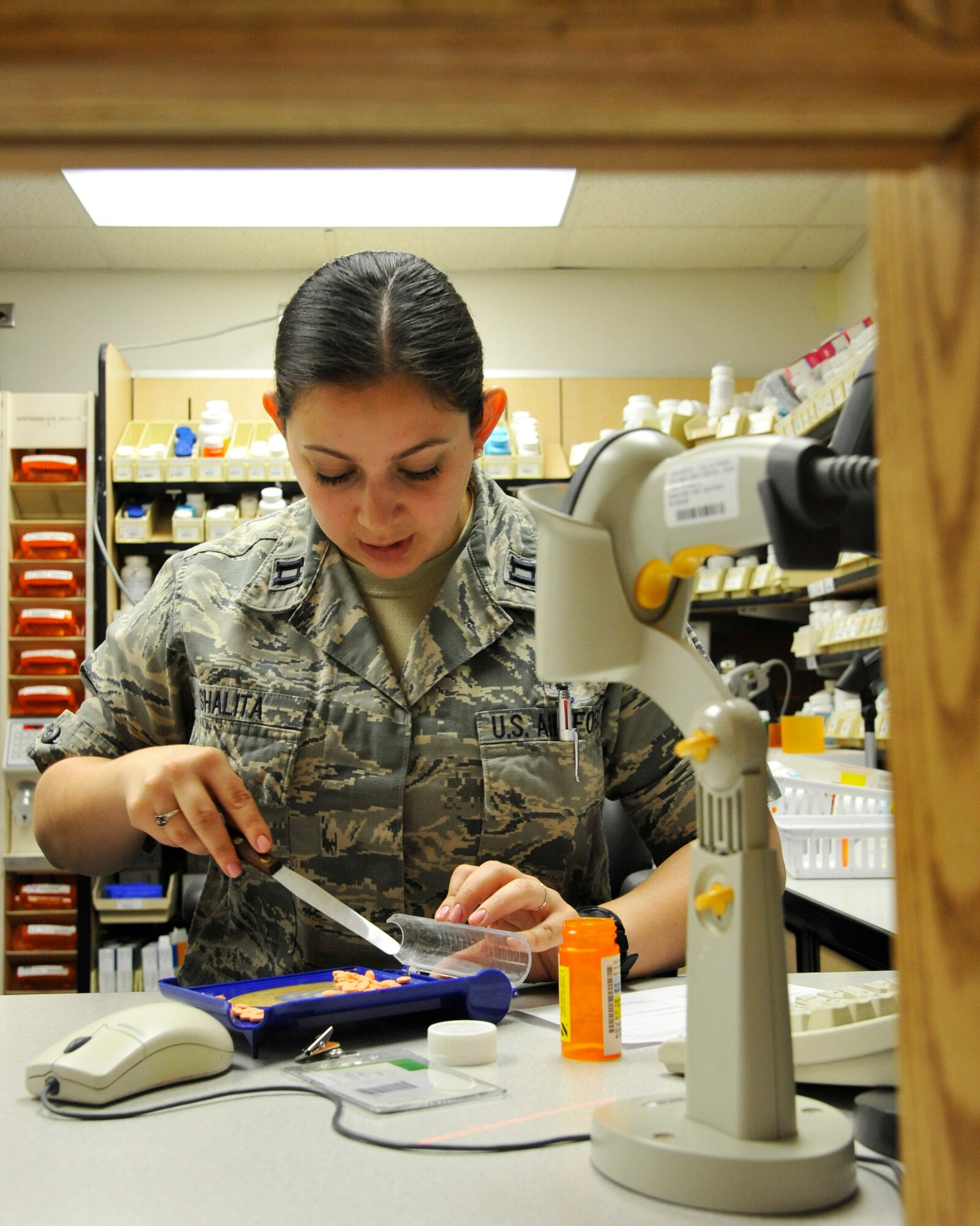 U.S. Air Force Capt. Jessica Shalita, 509th Medical Support Squadron pharmacist, counts controlled medications at Whiteman Air Force Base, Mo., June 18, 2014.  This procedure is done to ensure to ensure both the prescription count and remaining stock are accurate. (U.S. Air Force photo by Airman 1st Class Keenan Berry/Released)