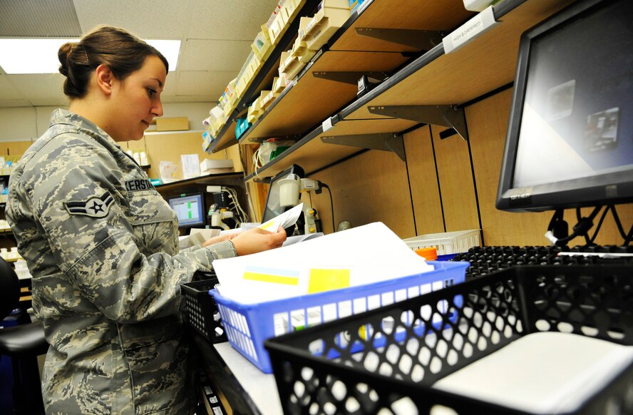 U.S. Air Force Airman 1st Class Kerstanoff, 509th Medical Support Squadron pharmacy technician, processes a patient’s order at Whiteman Air Force Base, Mo., June 18, 2014.  This procedure is done to ensure each patient receives his/her prescribed medications. (U.S. Air Force photo by Airman 1st Class Keenan Berry/Released)