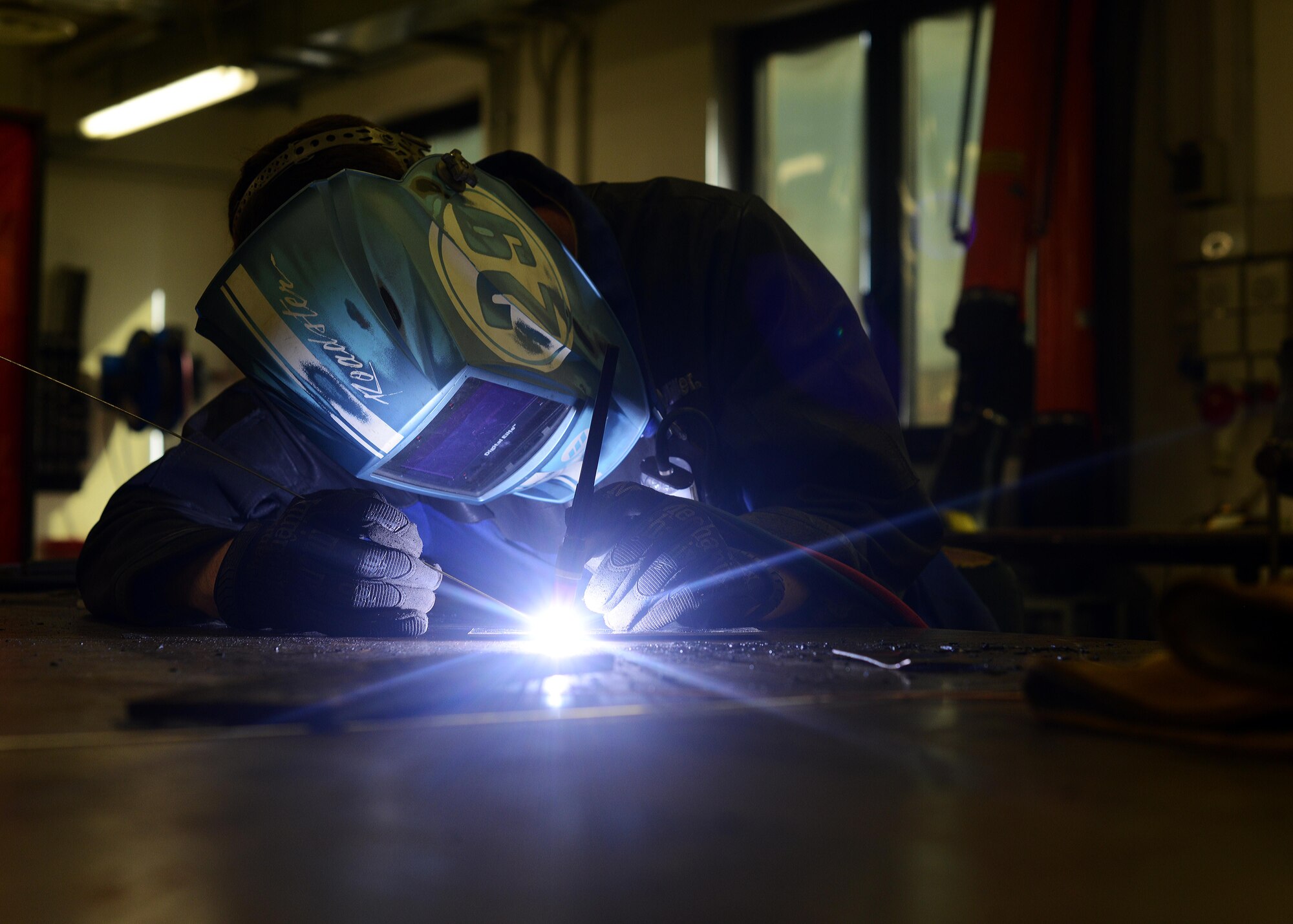 Airman 1st Class Daniel Gregory, 31st Maintenance Squadron metals technology journeyman, welds metal together, July 9, 2014, at Aviano Air Base, Italy. Fabrication flight is responsible for fashioning tools, aircraft components and other support systems tailored to the F-16 Fighting Falcon. (U.S. Air Force photo/Airman 1st Class Deana Heitzman)   