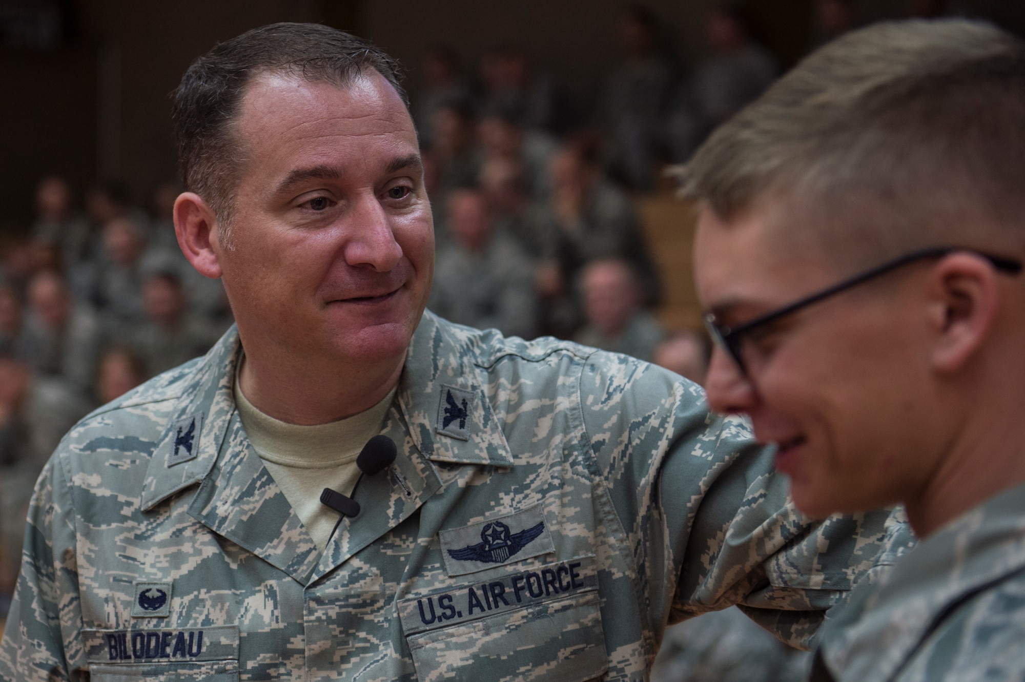 U.S. Air Force Col. Peter Bilodeau, 52nd Fighter Wing commander, speaks to an Airman during a commander's call at the Skelton Memorial Fitness Center July, 16, 2014, at Spangdahlem Air Base, Germany. Bilodeau and Chief Master Sgt. Brian Gates, 52nd FW command chief talked about their background, families and priorities, and later held a question and answer session. (U.S. Air Force photo by Senior Airman Rusty Frank/Released)
