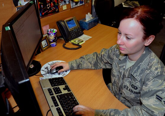 U.S. Air Force Airman 1st Class Jessica Doll, 351st Air Refueling Squadron aviation resource management journeyman from Ashville, N.C., updates aircrew flight hours and training accomplishments July 3, 2014, on RAF Mildenhall, England. Doll earned the Square D Spotlight for exhibiting the Air Force Core Value of Excellence in All We Do. (U.S. Air Force photo/Airman 1st Class Kyla Gifford/Released) 