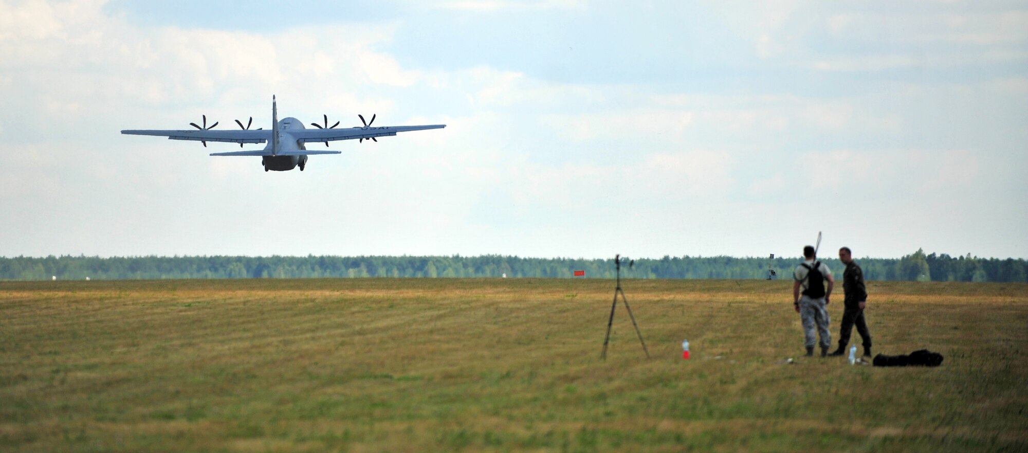 An U.S. Air Force C-130J Super Hercules from Ramstein Air Base, Germany, takes off from a grass landing strip on Powidz Air Base, Poland, July 11, 2014. Airmen from the 86th Airlift Wing are located in Poland for a forward training deployments employing training events with our NATO allies demonstrating shared commitments to peace. (U.S. Air Force photo by Senior Airman Christine Griffiths/Released)
