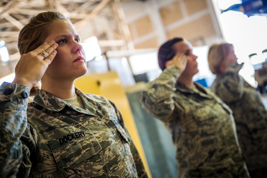 Staff Sgt. Kari Dockery, 387th Expeditionary Support Squadron force protection NCO, salutes during a dignified transfer practice July 12, 2014 at an undisclosed location in Southwest Asia. Dockery the other airmen train to handle those who have fallen in the line of duty with dignity and respect as they make their journey home to their families. These Airmen are available 24 hours, seven days a week for any dignified transfer. She is deployed from Edwards Air Force Base, Calif. in support of Operation Enduring Freedom. (U.S. Air Force photo by Staff Sgt. Jeremy Bowcock)