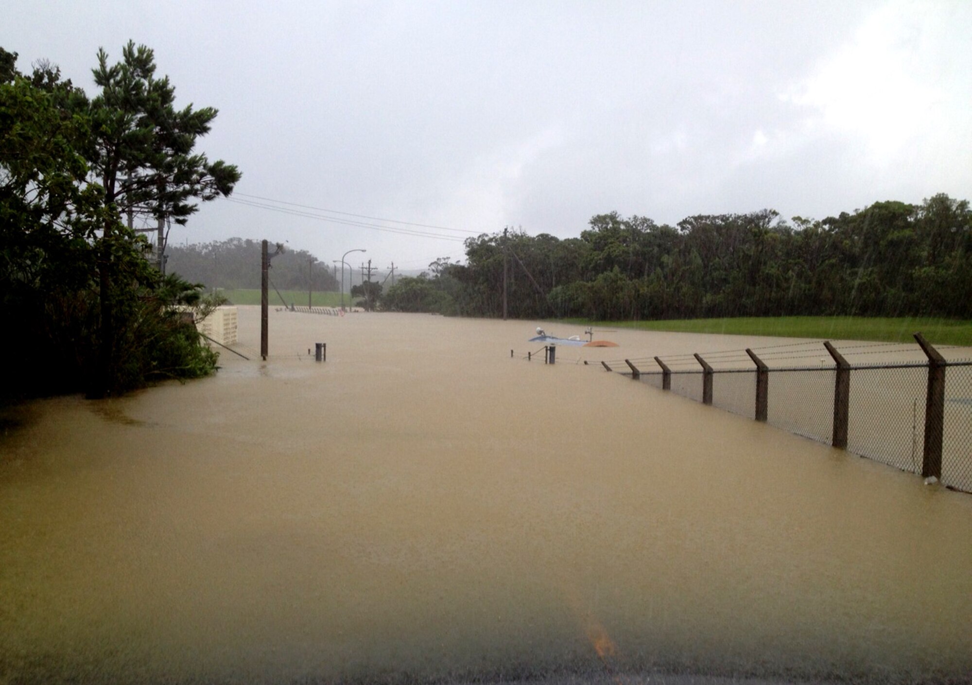 Two U.S. Air Force Airmen were rescued after being trapped inside a flooded guard shack during typhoon Neoguri on Kadena Air Base, Japan, July 9, 2014. The powerful typhoon caused a flash flood which engulfed the guard shack and trapped the Airmen inside. (Courtesy photo)