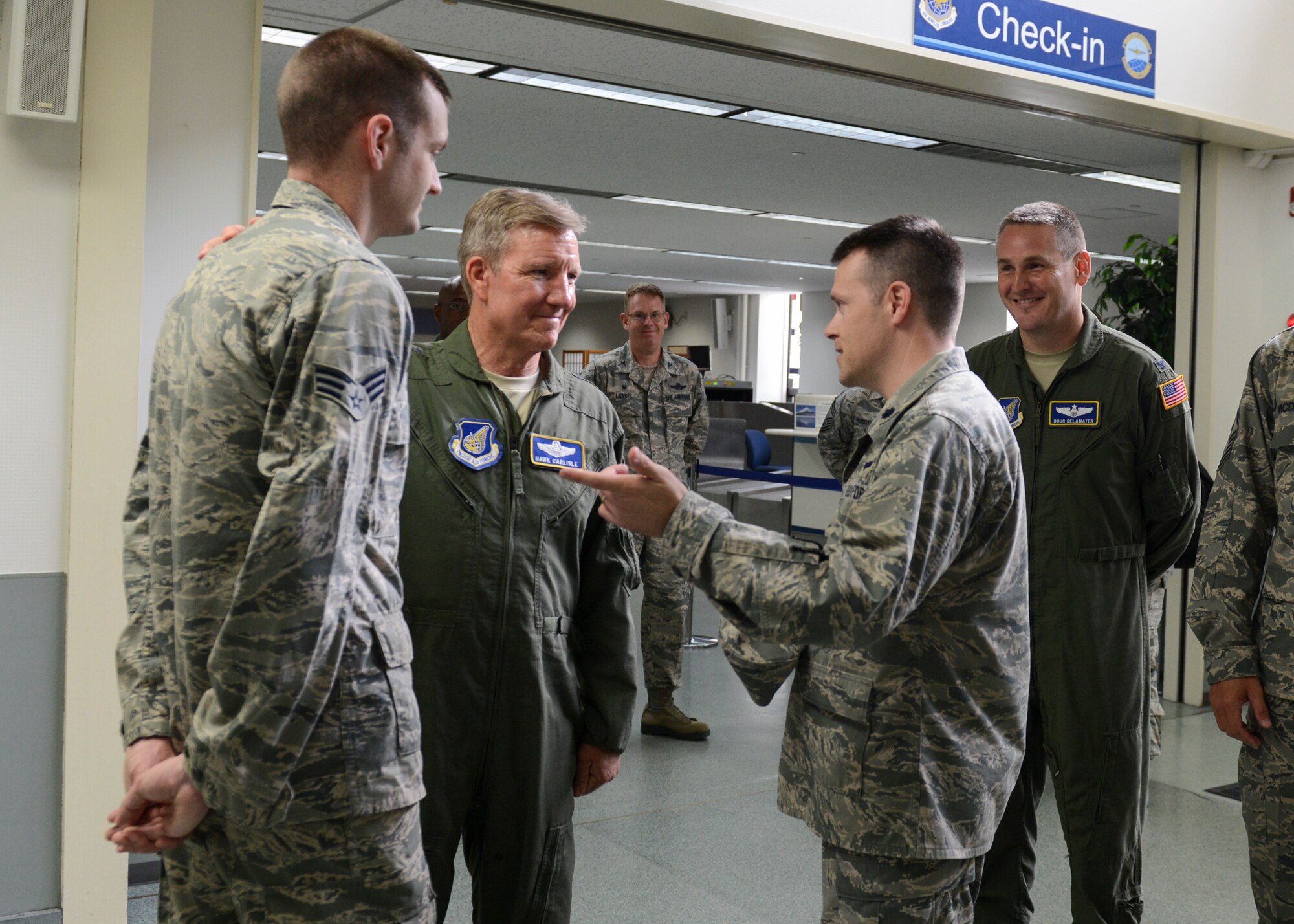 Gen. Hawk Carlisle, Pacific Forces commander, meets with an Airman from the 730th Air Mobility Squadron at the Yokota Passenger Terminal, July 13, 2014. Carlisle spent two days at Yokota to meet with Airmen and hosted an all call to address upcoming Air Force changes and thank his fellow Airmen for their hard work throughout the year. (U.S. Air Force photo by Airman 1st Class Meagan Schutter/Released)