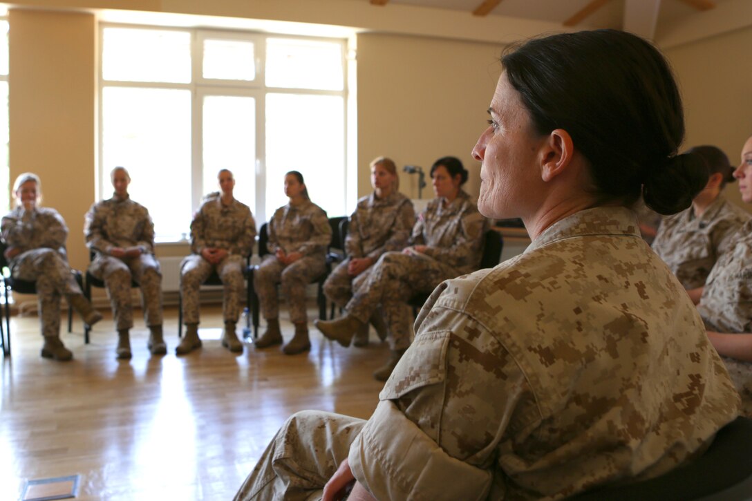 After U.S. Marines introduced Female Engagement Team concepts to Latvian Armed Forces servicemembers, Lt. Col. Michaela C. Coughlin, intelligence operations officer from Marine Forces Europe and Africa, receives feedback at the conclusion of the course in Adazi Military Base, Latvia, from June 17-19. This introduction was the first step for the Baltic partner to further evaluate the capability for use within their own military.