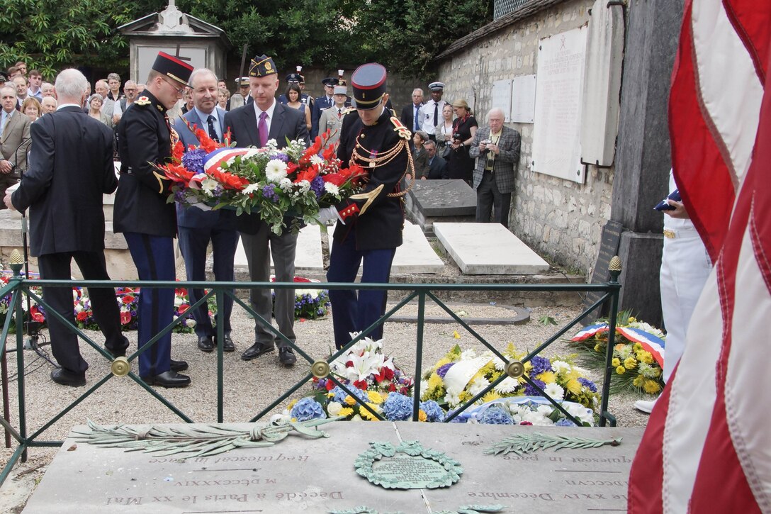 An American flag is lowered during an annual commemorative ceremony at the tomb of Maj. Gen. Marquis de Lafayette July 4. Each year, on America's Independence Day, French and American military personnel, dignitaries and societies place wreaths at the edge of Lafayette's tomb and lower the American flag, which is flown above the grave. The flag is then replaced, raised and flown until the ensuing year's ceremony. The memorial event, which began after World War I, honors Lafayette for his roles in both American and French conflicts such as the American War of Independence and the French Revolution.