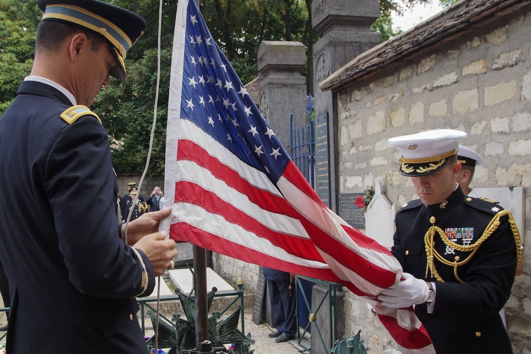 An American flag is lowered during an annual commemorative ceremony at the tomb of Maj. Gen. Marquis de Lafayette July 4. Each year, on America's Independence Day, French and American military personnel, dignitaries and societies place wreaths at the edge of Lafayette's tomb and lower the American flag, which is flown above the grave. The flag is then replaced, raised and flown until the ensuing year's ceremony. The memorial event, which began after World War I, honors Lafayette for his roles in both American and French conflicts such as the American War of Independence and the French Revolution. 