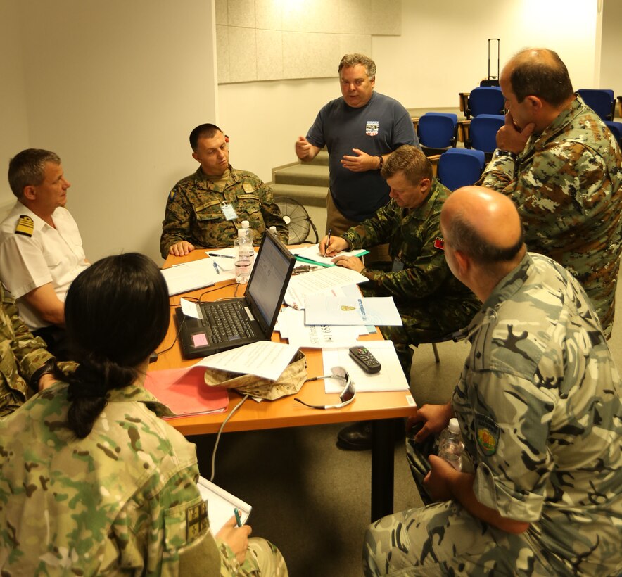 Discussions continue on disaster relief for an exercise during a logistics conference at the Slovenian Ministry of Defense in Ljubljana, Slovenia, July 3. Eleven nations participated in the small exercise designed to bring international cooperation together to plan humanitarian assistance for historical natural disasters.