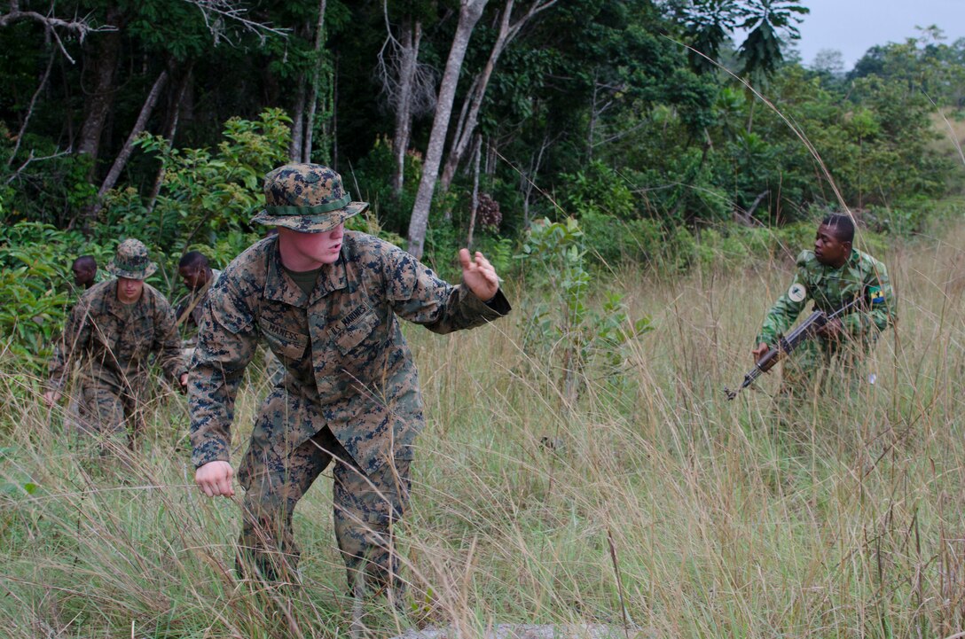Lance Cpl. Forrest Maness, a Marine with Special-Purpose Marine Air-Ground Task Force Africa 14, leads an assault on an objective during training in Gabon, June 13, 2014. A team of 15 Marines and sailors trained with their Gabonese counterparts from the Agence Nationale des Parcs Nationaux and the Gabonese military and Gendarmerie to demonstrate tactics that could then be applied to combat all types of illicit activities, to include narcotics trafficking.