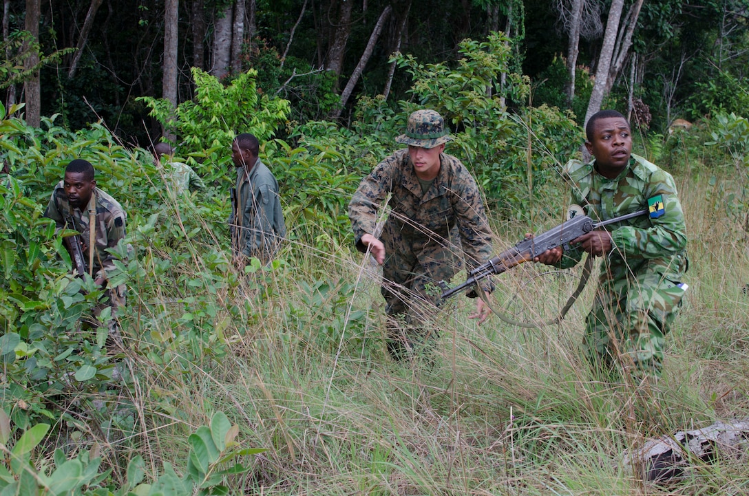 Lance Cpl. Michael Kelly, a Marine with Special-Purpose Marine Air-Ground Task Force Africa 14, leads an assault on an objective during training in Gabon, June 13, 2014. A team of 15 Marines and sailors trained with their Gabonese counterparts from the Agence Nationale des Parcs Nationaux and the Gabonese military and Gendarmerie to demonstrate tactics that could then be applied to combat all types of illicit activities, to include narcotics trafficking.