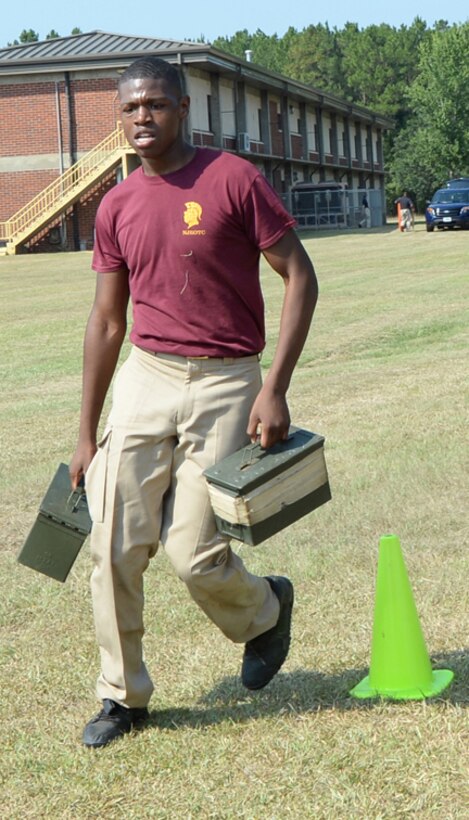 Jaquavious Thomas, Navy Junior Reserve Officer Corps Training cadet, Coffee County High School, runs with sand-filled ammunition cans to complete the Combat Fitness Test July 9 at Marine Corps Logistics Base Albany.