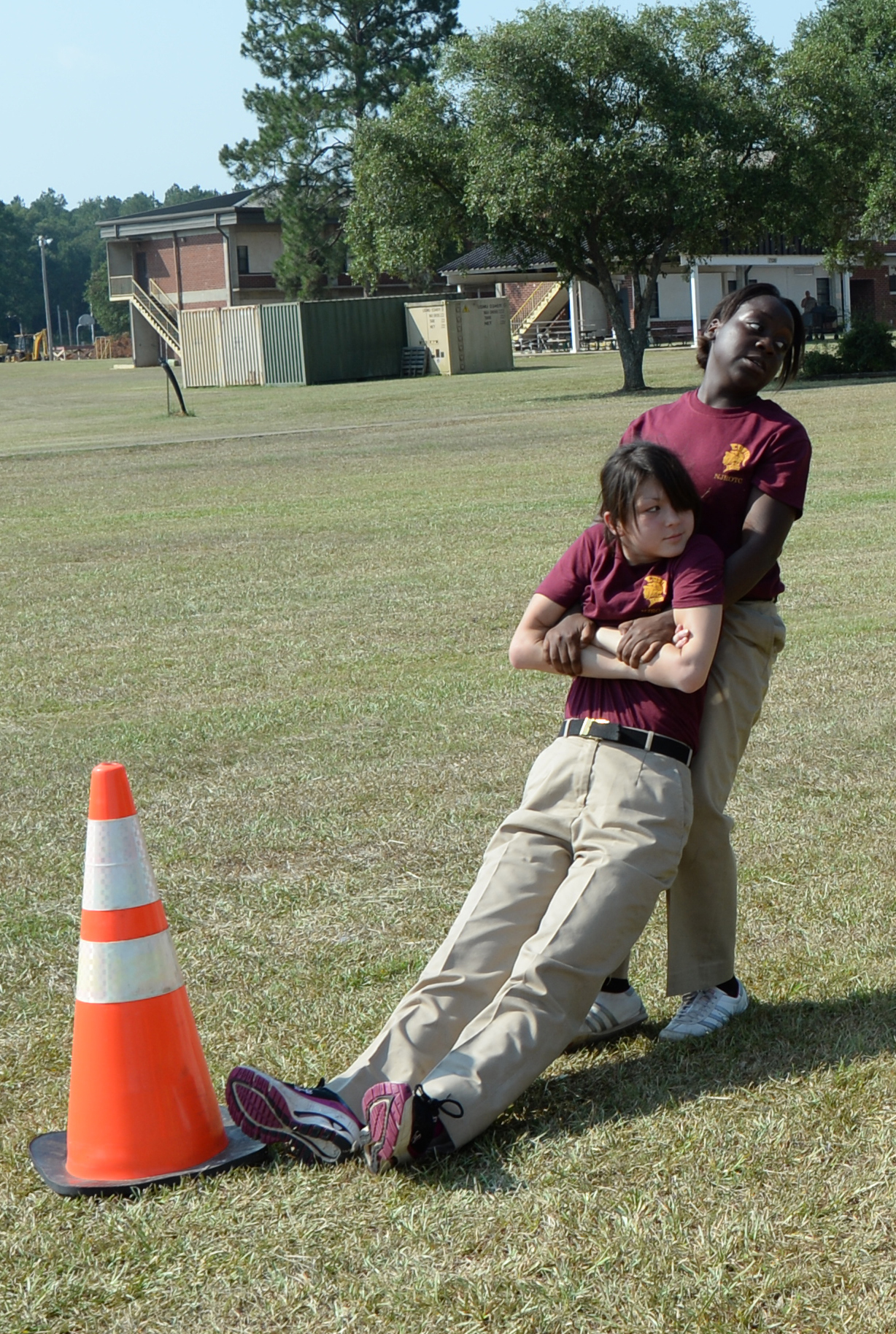 Vernetta Watts, Navy Junior Reserve Officer Training Corps cadet, Coffee County High School, performs a buddy drag of Erica Steedley, NJROTC cadet, Coffee County High School, to complete the Combat Fitness Test July 9 at Marine Corps Logistics Base Albany.