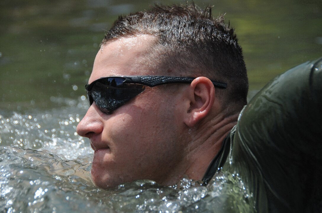 Naval Reserve Officer Training Corps Midshipman 2nd Class J.P. Snyder, from Virginia Tech University, swims across a stream while practicing river crossing techniques at the Marine Corps Mountain Warfare Training Center, Bridgeport, Calif. during midshipmen summer training, July 13. The 155 Naval Academy and Naval Reserve Officer Training Corps midshipmen were scheduled to spend 10 days at MCMWTC learning survival and tactical skills in a mountainous environment. (Official U.S. Navy photo by Lt. Matthew Comer)