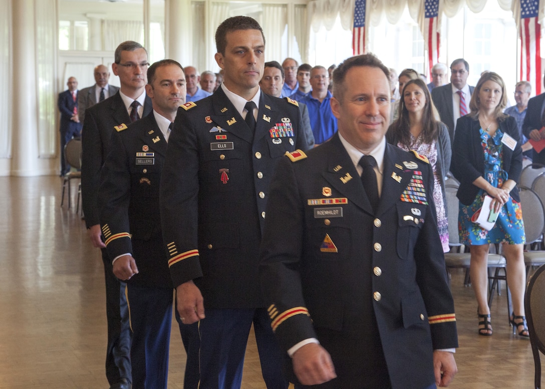 Col. Steven J. Roemhildt, Great Lakes and Ohio River division commander, leads the Offical procession party to the stage during the Detroit District change of command ceremony July 10, 2014; following him are Lt. Col. Robert J. Ells, the outgoing district commander, Lt. Col. Michael L. Sellers, the incoming district commander, and Scott Thieme, the deputy distict engineer for project management.