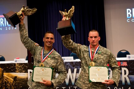 Sgt. 1st Class Scott Stimpson, left, a recruiting and retention noncommissioned officer with the Recruiting and Retention Battalion, Oregon Army National Guard, and Spc. Ryan Montgomery, an infantryman with the Arkansas Army National Guard's 39th Infantry Brigade Combat Team, hold their trophies high as the Army National Guard noncommissioned officer and junior enlisted Soldier of the year at an awards ceremony for the Army National Guard Best Warrior Competition, July 16, 2014 at Camp Robinson, Ark. After a grueling three days, the two competitors earned the chance to represent the Army Guard at the Department of the Army competition to be held later this year. 