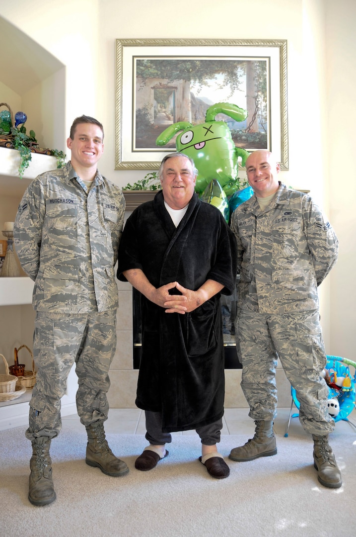 California Air National Guard Airmen 1st Class David Hutchason and Tod Miley, both members of the 144th Fighter Wing, stand beside retired Air Force Chief Master Sgt. Lawrence Pollastrini (center), Feb. 5, 2012. Their meeting comes one week after Pollastrini suffered a heart attack and Airmen Hutchason and Miley saved his life by administering CPR.