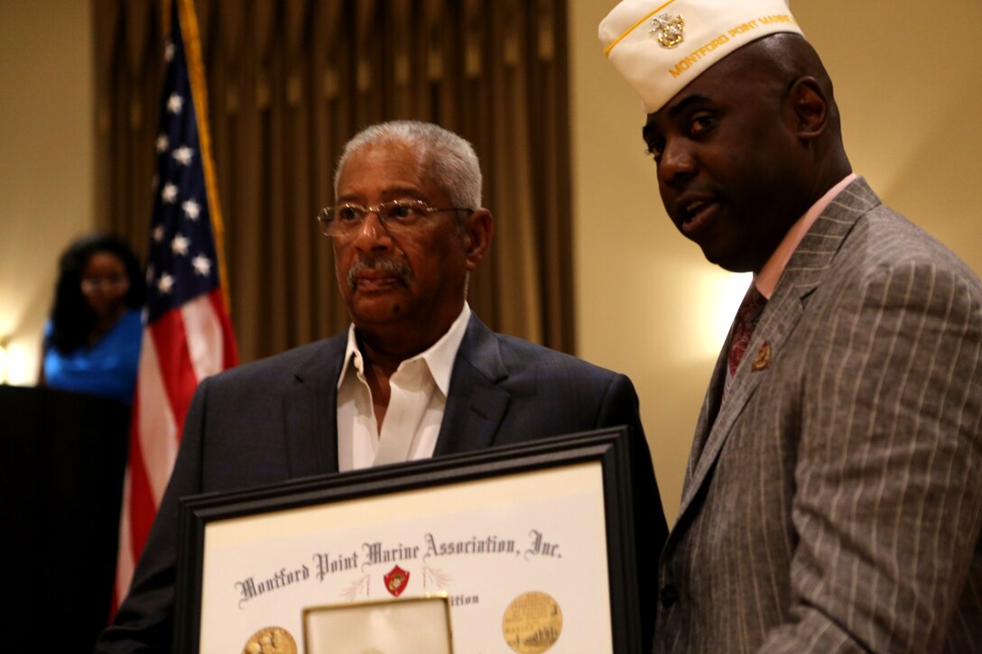 Lawrence Robert Gabriel accepts the Congressional Gold Medal on behalf of his father, Lawrence Gabriel, one of the original Montford Point Marines, July 16, 2014. The national Montford Point Marine Association’s 49th Annual National Convention is focused on “Preserving the Legacy,” by educating Marines and families throughout the week. The President’s Reception not only included the medal ceremony but also focused on the rededication to the Montford Point Marines. 