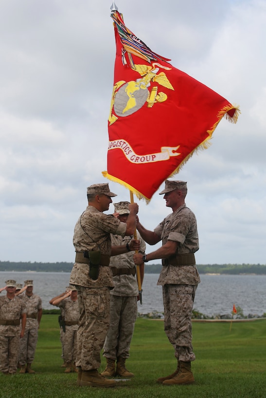 Brigadier Gen. Edward D. Banta (right) passes the 2nd Marine Logistics Group colors to Brig. Gen. Charles G. Chiarotti (left) during a change of command ceremony for 2nd MLG aboard Camp Lejeune, N.C., July 15, 2014. Banta turned over his leadership of approximately 8,000 Marines and sailors after serving two years as the 2nd MLG commanding general. 