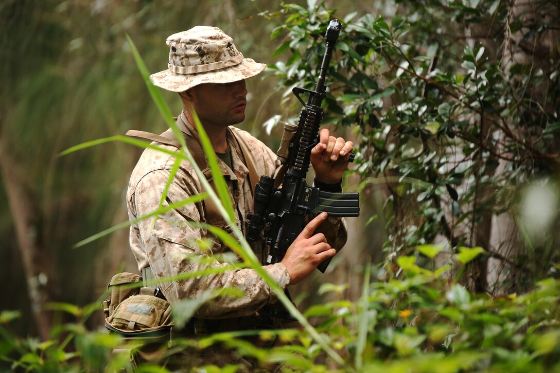 KAHUKU TRAINING AREA, Hawaii - Sgt. Robert Nishnic, a Marine with India Company, 3rd Battalion, 3rd Marine Regiment, and platoon sergeant for second platoon within Company Landing Team One, prepares to assault an objective in the forest of Kahuku Training Area during Rim of the Pacific (RIMPAC) Exercise 2014, July 13. Twenty-two nations, more than 40 ships and submarines, about 200 aircraft and 25,000 personnel are participating in RIMPAC from June 26 to Aug. 1 in and around the Hawaiian Islands and Southern California. The world's largest international maritime exercise, RIMPAC provides a unique training opportunity that helps participants foster and sustain the cooperative relationships that are critical to ensuring the safety of sea lanes and security on the world's oceans. RIMPAC 2014 is the 24th exercise in the series that began in 1971. (U.S. Marine Corps photo by Sgt. Sarah Dietz/Released)