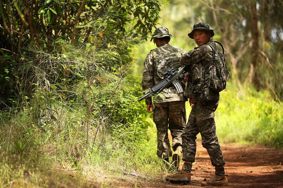 KAHUKU TRAINING AREA, Hawaii - Republic of Korea Marine Corps Staff Sgt. Cho Myeong Sang, infantryman with Company Landing Team One, patrols down a road at Kahuku Training Area during Rim of the Pacific (RIMPAC) Exercise 2014, July 13. Twenty-two nations, more than 40 ships and submarines, about 200 aircraft and 25,000 personnel are participating in RIMPAC from June 26 to Aug. 1 in and around the Hawaiian Islands and Southern California. The world's largest international maritime exercise, RIMPAC provides a unique training opportunity that helps participants foster and sustain the cooperative relationships that are critical to ensuring the safety of sea lanes and security on the world's oceans. RIMPAC 2014 is the 24th exercise in the series that began in 1971. (U.S. Marine Corps photo by Sgt. Sarah Dietz/Released)