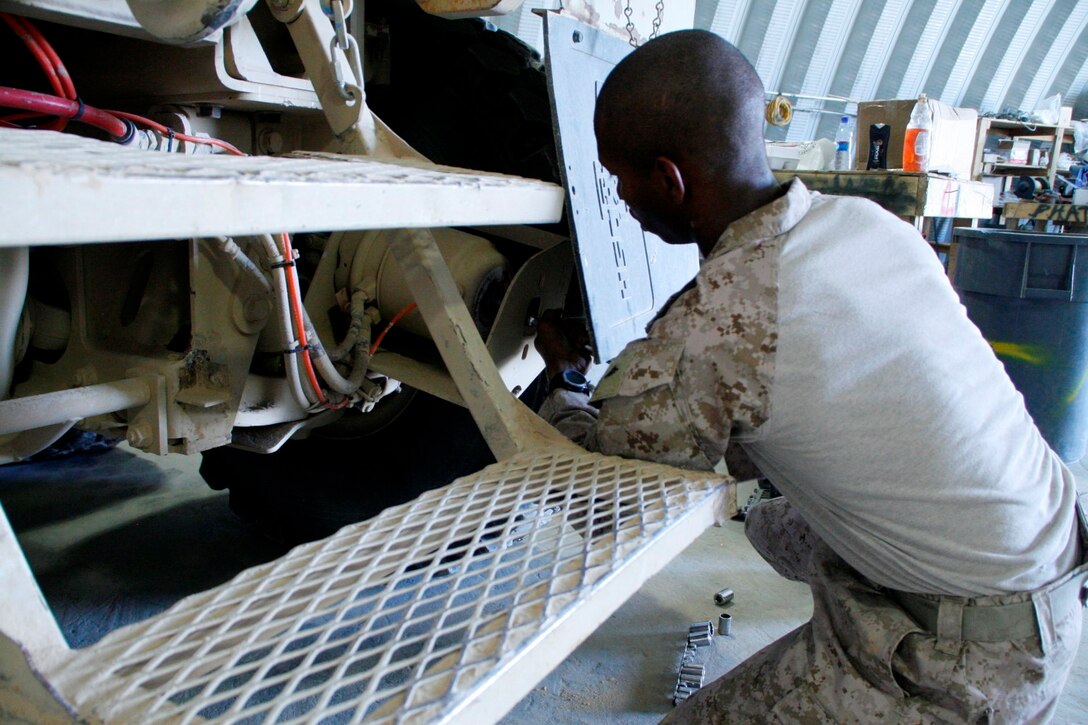 Lance Cpl. Darrius Arnold, a hazardous material maintainer and motor transport mechanic with 1st Battalion, 2nd Marine Regiment, works on the brakes of one of the Mine-Resistant Ambush Protected vehicles aboard Camp Leatherneck, Helmand province, Afghanistan, July 11, 2014. Arnold, a native of Virginia Beach, Virginia, is one of the mechanics responsible for ensuring vehicles run properly and effectively in order to complete the mission for coalition forces serving with Regional Command (Southwest).