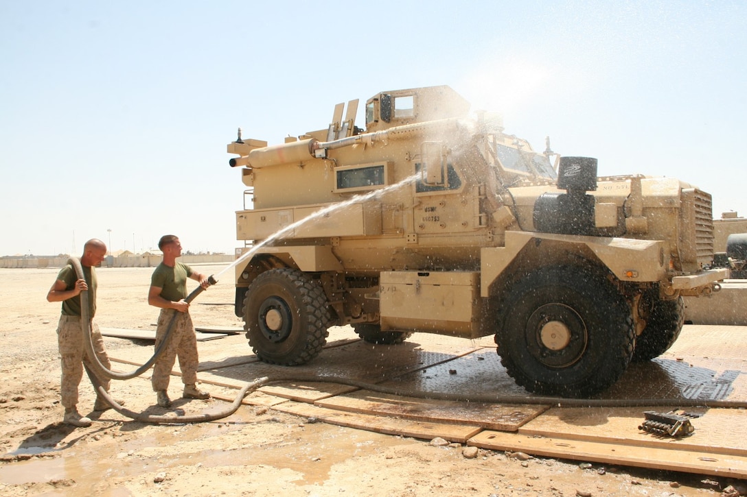 Motor transport Marines with 1st Battalion, 2nd Marine Regiment, wash a Mine-Resistant Ambush Protected vehicle aboard Camp Leatherneck, Helmand province, Afghanistan, July 11, 2014. All the vehicles are cleaned, inside and out, and then fluids and fuel are drained to a safe level before being retrograded.