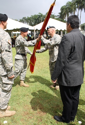 Lt. Col. Christopher W. Crary (second from right) accepts the command colors from Pacific Ocean Division Commander Maj. Gen. Richard L. Stevens during a military ceremony held July 17 on Palm Circle parade field at Fort Shafter, Hawaii. Crary is the 69th commander of the U.S. Army Corps of Engineers Honolulu District. At left is outgoing District Commander Lt. Col. Thomas D. Asbery and Tony Paresa, Deputy District Engineer for Programs and Project Management. 