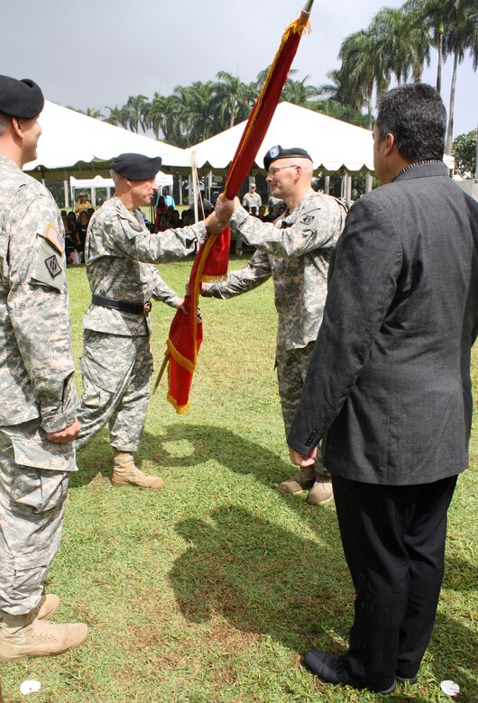 Lt. Col. Christopher W. Crary (second from right) accepts the command colors from Pacific Ocean Division Commander Maj. Gen. Richard L. Stevens during a military ceremony held July 17 on Palm Circle parade field at Fort Shafter, Hawaii. Crary is the 69th commander of the U.S. Army Corps of Engineers Honolulu District. At left is outgoing District Commander Lt. Col. Thomas D. Asbery and Tony Paresa, Deputy District Engineer for Programs and Project Management. 