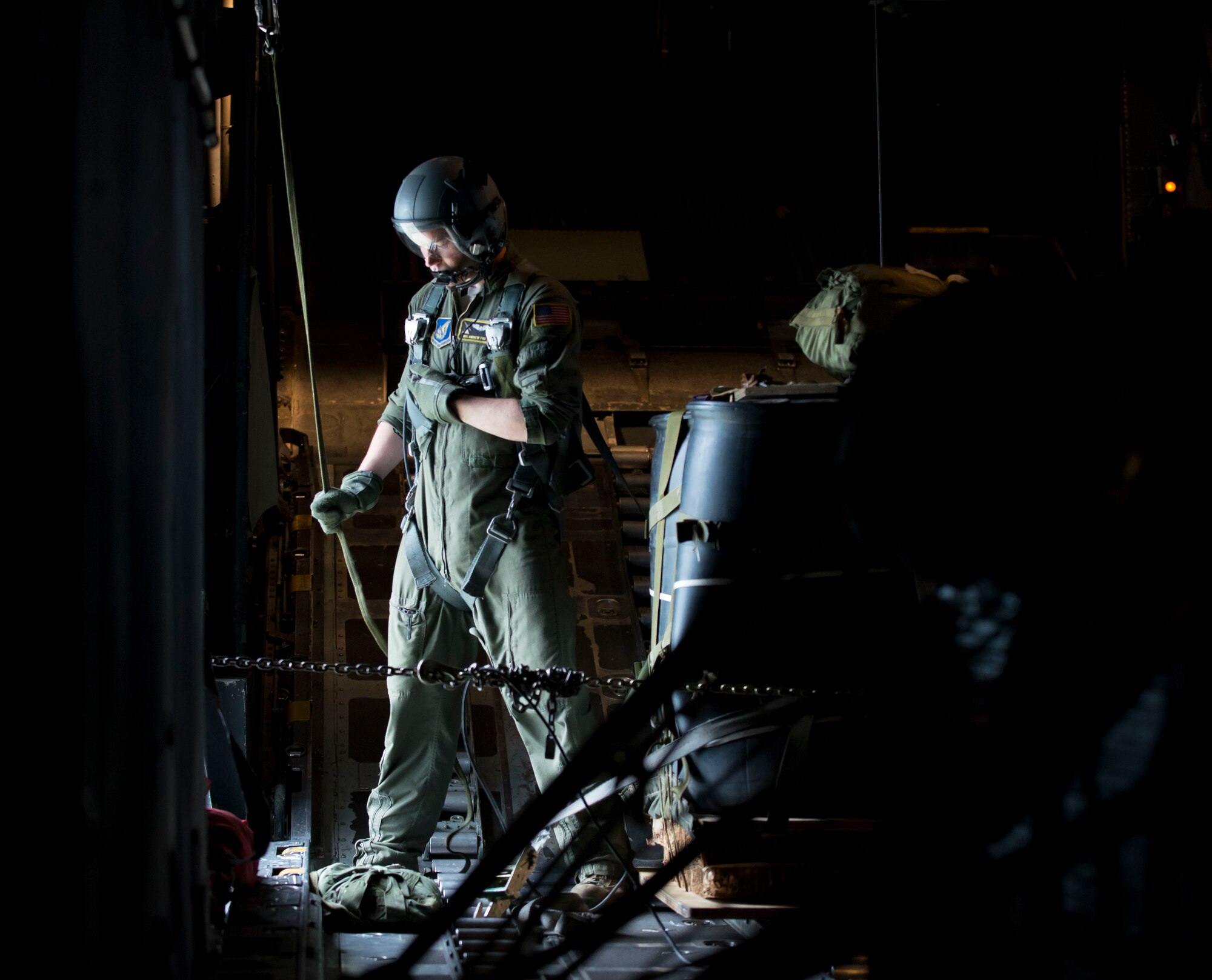 Airman 1st Class Andrew Fox, 36th Airlift Squadron C-130 Hercules loadmaster, waits for the signal to drop a simulated cargo package at Yokota Air Base, Japan, July 17, 2014. The 36th Airlift Squadron routinely trains to stay ready in case of a contingency. (U.S. Air Force photo by Airman 1st Class Meagan Schutter/Released)