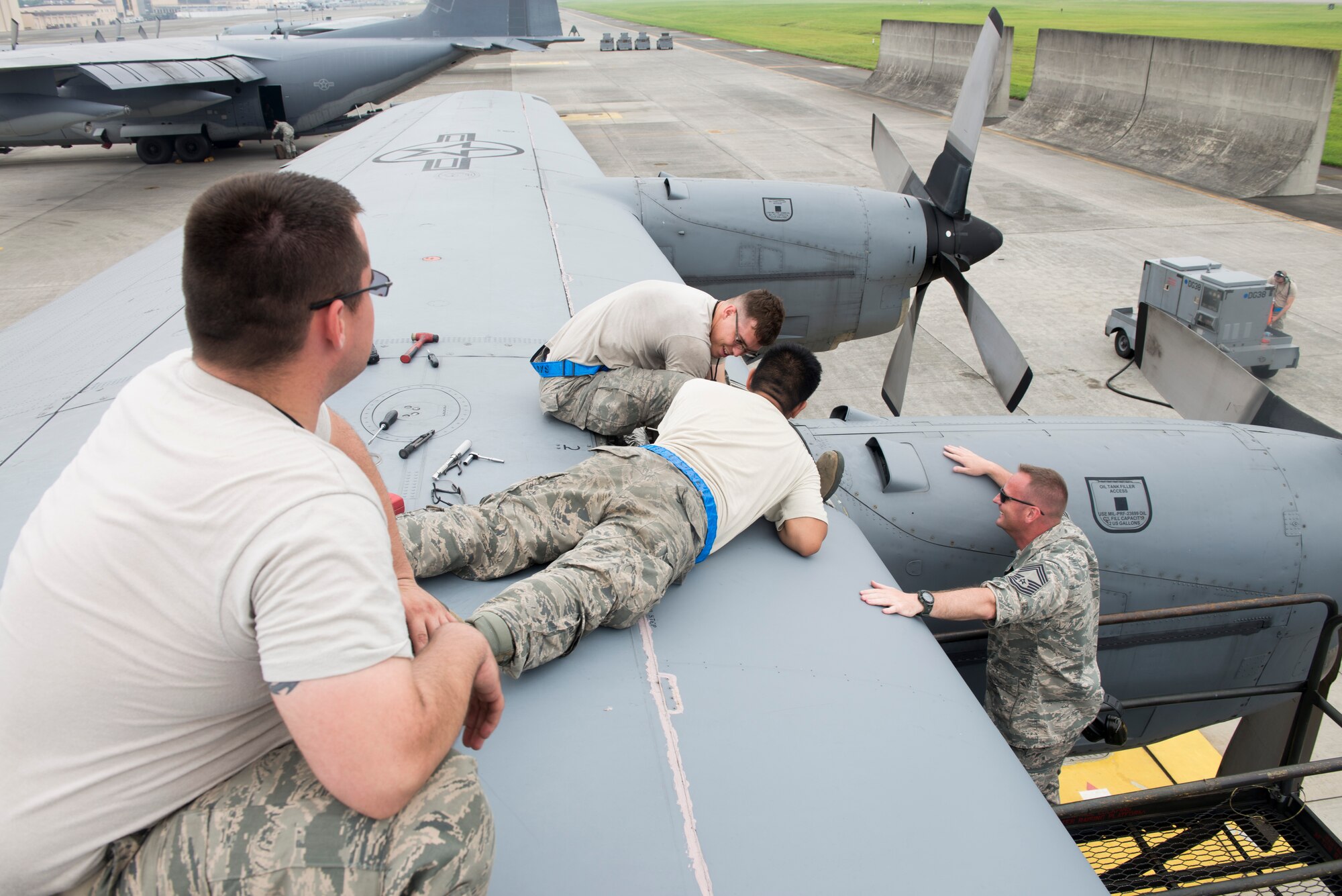 YOKOTA AIR BASE, Japan -- Airmen with the 374th Aircraft Maintenance Squadron exchange an engine valve on a C-130 Hercules during routine operations at Yokota July 17, 2014. The 374 AW provides tactical combat mobility and humanitarian aid capabilities as the primary airlift hub in the Pacific region. (U.S. Air Force photo by Airman 1st Class David D. Danford/Released)