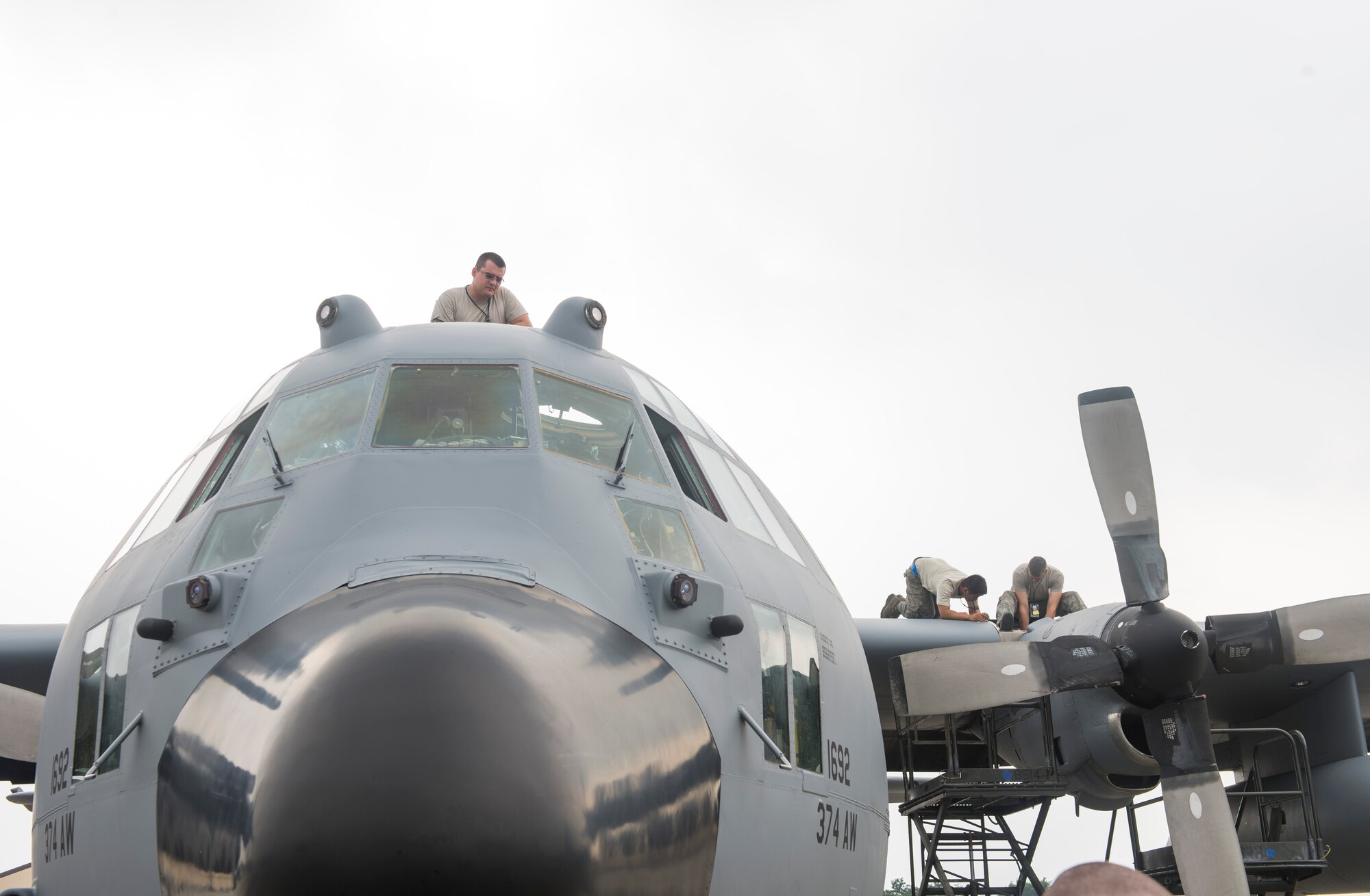 YOKOTA AIR BASE, Japan -- Airmen with the 374th Aircraft Maintenance Squadron conducts pre-flight maintenance on a C-130 Hercules during routine operations at Yokota July 17, 2014. The 374 AW provides tactical combat mobility and humanitarian aid capabilities as the primary airlift hub in the Pacific region. (U.S. Air Force photo by Airman 1st Class David D. Danford/Released)