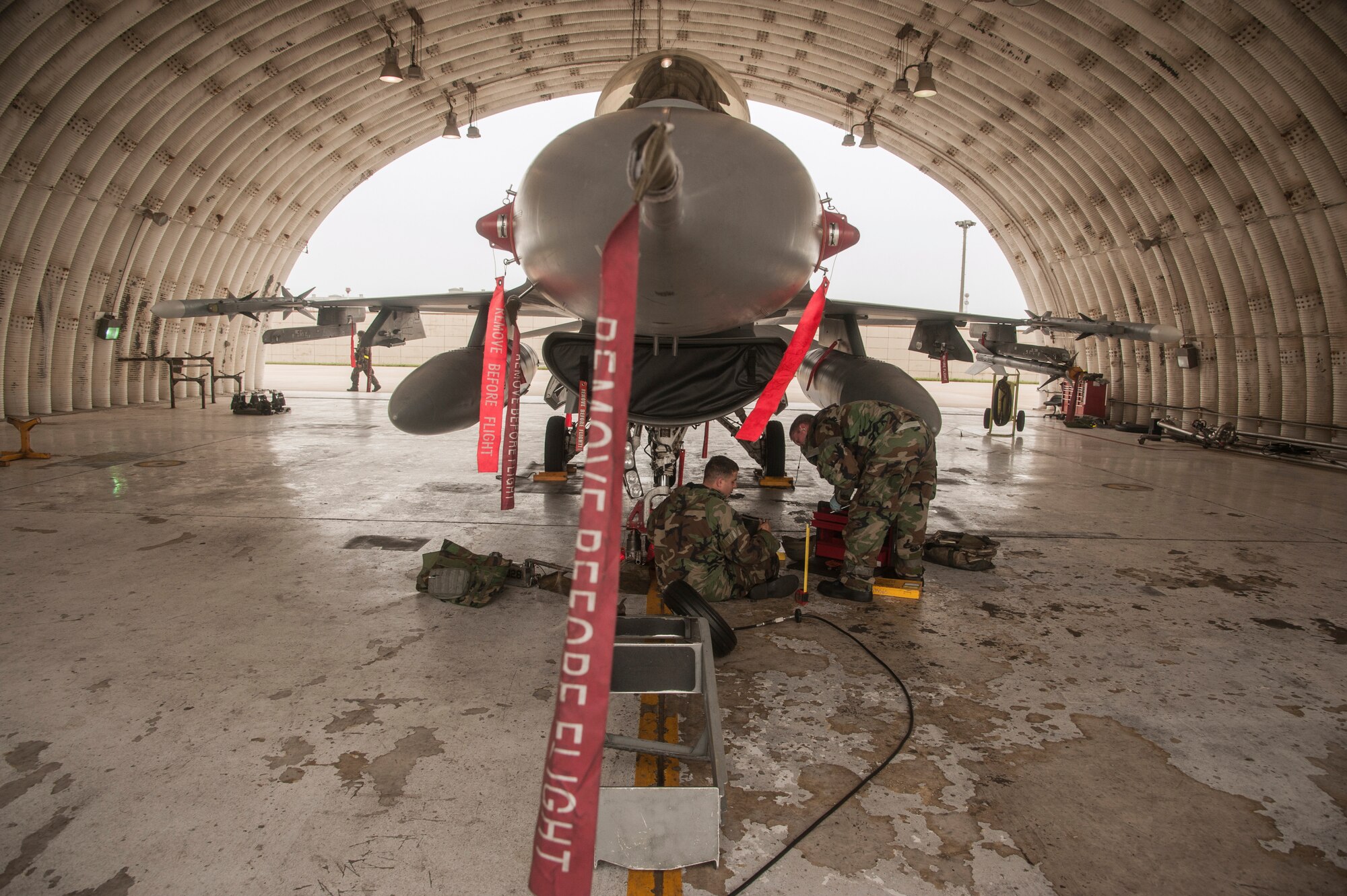 Wolf Pack maintainers change a tire of an F-16 Fighting Falcon’s front wheel assembly during exercise Beverly Midnight 14-2 at Kunsan Air Base, Republic of Korea, July 16, 2014. The Operational Readiness Exercise assesses mission capabilities and ensures the Wolf Pack is in a constant state of readiness. (U.S. Air Force photo by Senior Airman Taylor Curry/Released) 